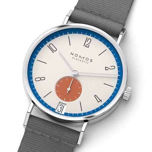Nomos Glashütte Tangente 38 Datum Zirkus Der sanfte Cremeton des Zifferblatts bildet beim Modell Zirkus die Manege, über das sich in Blau und mit roter Spitze das Zelt spannt.