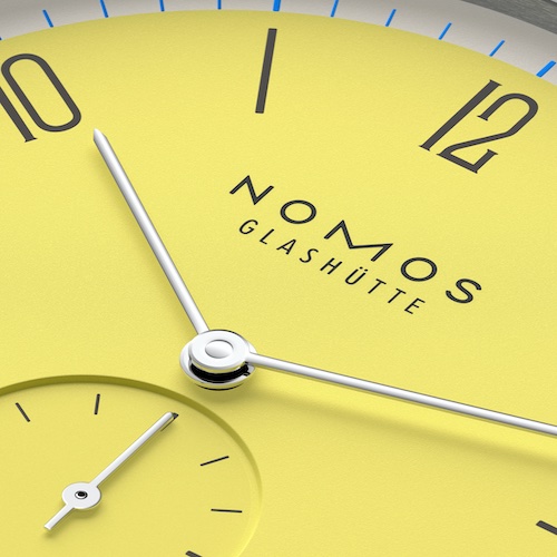 Nomos Glashütte Tangente 38 Datum Kanari Das fröhliche Kanari-Gelb ahmt das Federkleid des Vogels nach, der fast den gleichen Namen trägt, und wächst als Ginster und Raps auf unseren Feldern.